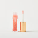 Jeté | | A bottle of Merit lip oil in shade Jeté displayed next to its applicator. 