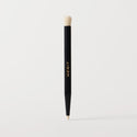 Master || A black cosmetic brush with a flat, dual-ended design, featuring the brand name 'MERIT' in gold lettering on the side.