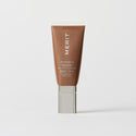 Master || A tube of MERIT brand mineral sunscreen with a sheer tint finish, providing broad spectrum 50 UVA/UVB protection, displayed against a white background. Shade 6