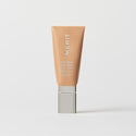 Master || A tube of MERIT brand mineral sunscreen with a sheer tint finish, providing broad spectrum 50 UVA/UVB protection, displayed against a white background. Shade 18