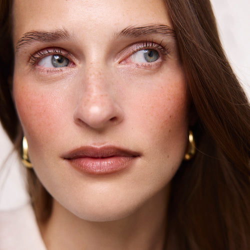 Persimmon | face::fair  |  Model is wearing Flush Balm in shade Persimmon.