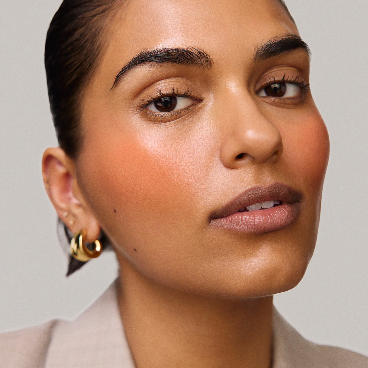 Master || Model is wearing Flush Balm in shade Terracotta.