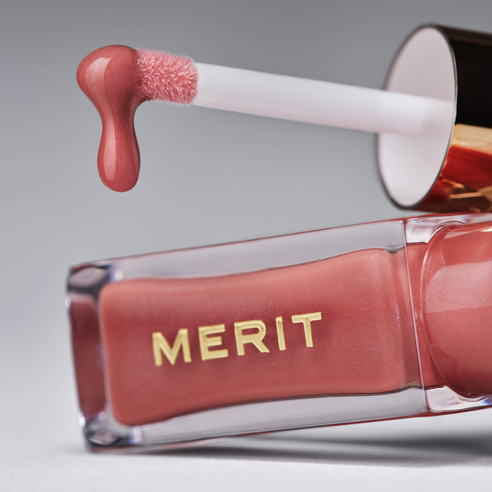 Master || Zoomed in image of Shade Slick with the lip oil dripping off the applicator